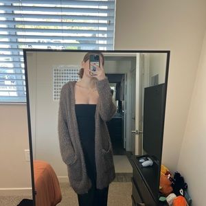 Fuzzy long sleeve sweater with pockets and a hood